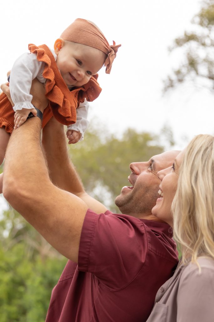 Fall Family Photos - Dad holding up to the sky while mom and dad smile MNPPHOTOS.COM